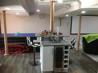 a room with a table and chairs and a bed at Privacy, entertainment, comfort galore 2 BR LR 1BA Home Theater, Pool Table in Suffield