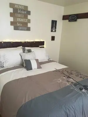 a bedroom with a large bed in a room at Meet the browns with parking in Schenectady