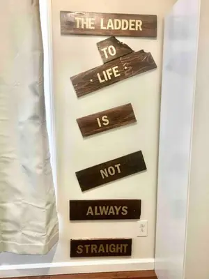 a shelf with wooden signs on a wall at Meet the browns with parking in Schenectady