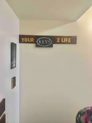 a sign that reads your keys life on a wall at Meet the browns with parking in Schenectady