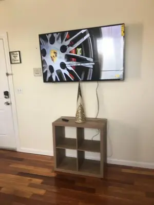 a flat screen tv on a wall above a table at Meet the browns with parking in Schenectady