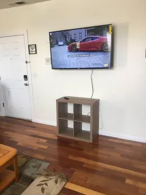 a living room with a flat screen tv on the wall at Meet the browns with parking in Schenectady