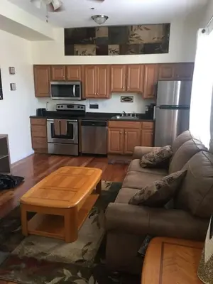 a living room with a couch and a table at Meet the browns with parking in Schenectady