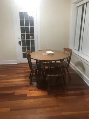 a table and chairs in a room with a window at 2 bedroom suite in Schenectady
