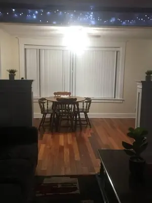 a living room with a table with stars on the ceiling at 2 bedroom suite in Schenectady