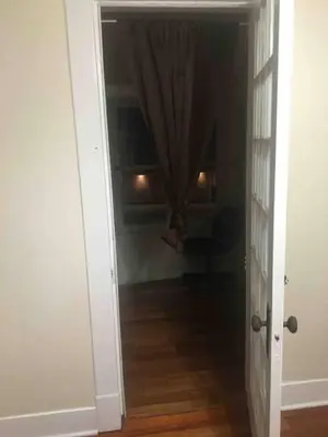 an open door to a hallway with a room at 2 bedroom suite in Schenectady