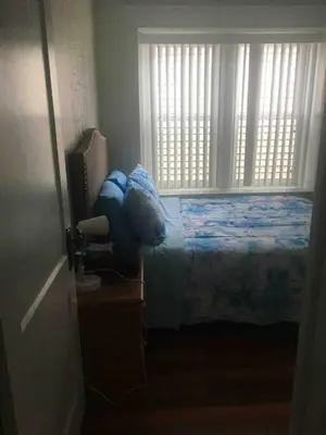 a bedroom with a bed and a window at 2 bedroom suite in Schenectady