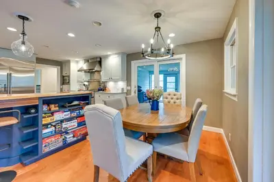 a dining room with a wooden table and chairs at Monterey Home with Hot Tub, Pool and Game Room! in Monterey