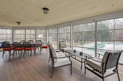 a large room with tables and chairs and windows at Monterey Home with Hot Tub, Pool and Game Room! in Monterey