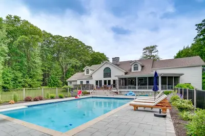 a home with a swimming pool and a house at Monterey Home with Hot Tub, Pool and Game Room! in Monterey