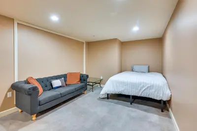 a living room with a couch and a bed at Monterey Home with Hot Tub, Pool and Game Room! in Monterey