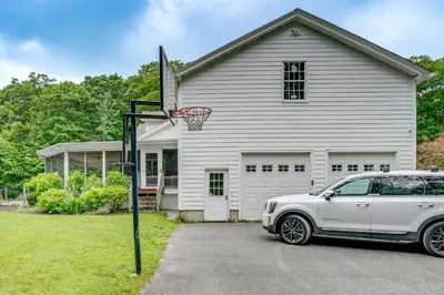 a white car parked in front of a house with a basketball hoop at Monterey Home with Hot Tub, Pool and Game Room! in Monterey