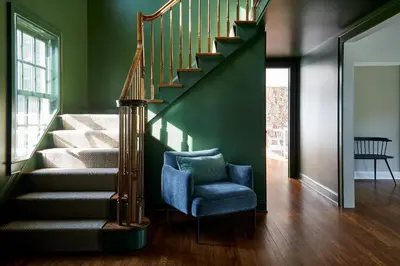 a stairway with a blue chair and a stair case at The Kent Collection - The Firefly Inn in Kent