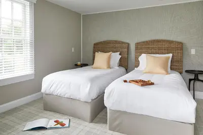 a bedroom with two beds and a book on the floor at The Kent Collection - The Firefly Inn in Kent