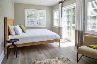 a bedroom with a bed and two windows at The Kent Collection - The Firefly Inn in Kent