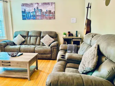 a living room with two couches and a coffee table at Bright, Stylish & Cozy 2Bed Unit w/Backyard & Grill Close to NYC! in Haledon