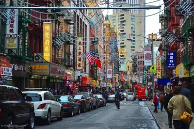 a busy city street with cars and people walking on the street at 2 Bedroom Apt with 3 Beds - Friends & Family in New York