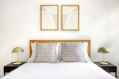 a bedroom with a white bed with two lamps at BK Heights 2BR w WD Elevator nr Promenade NYC-910 in Brooklyn