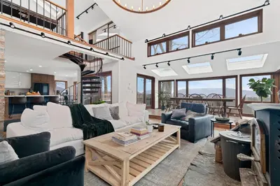 a living room with two couches and a table at 5 Star Gorgeous Cliffside Chalet with Panoramic Views in Tannersville