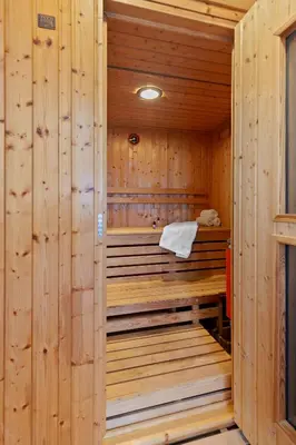 a sauna in a wooden cabin with a towel in it at 5 Star Gorgeous Cliffside Chalet with Panoramic Views in Tannersville