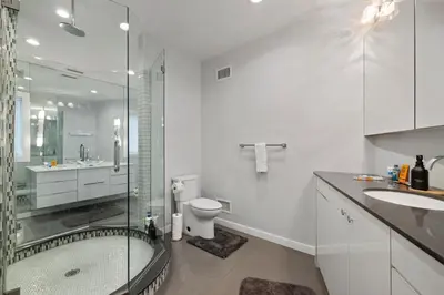 a bathroom with a shower toilet and a sink at Piermont Waterfront Villa with Hot Tub in Piermont