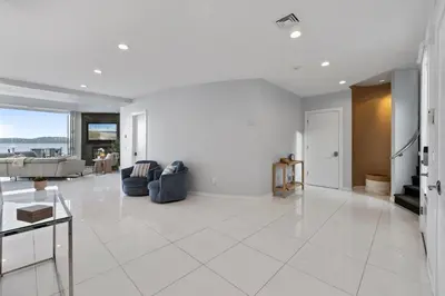 a large white living room with a couch and a table at Piermont Waterfront Villa with Hot Tub in Piermont