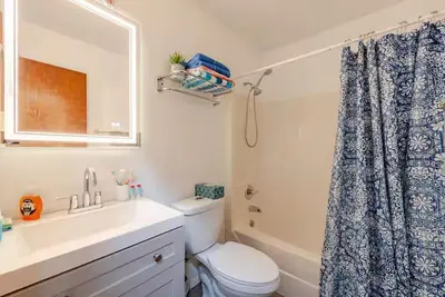 a bathroom with a sink and a toilet and a mirror at Poconos Chalet in Tobyhanna