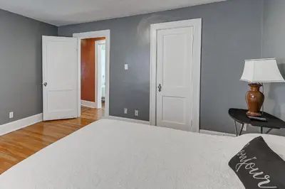 a bedroom with gray walls and a bed with a lamp at Charming Connecticut Retreat Near Museums and Hiking in Waterbury