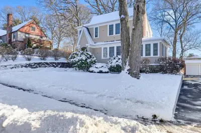 a white house with snow on the driveway at Charming Connecticut Retreat Near Museums and Hiking in Waterbury