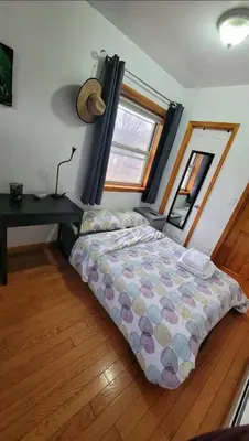 a bedroom with a bed and a desk in it at New York in Woodside
