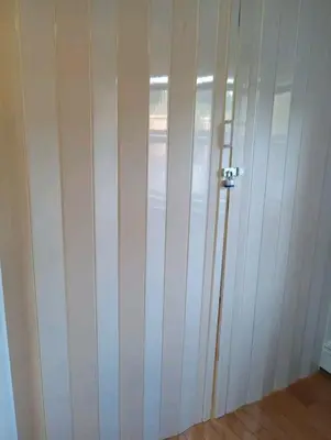 a room with a white closet with a door at New York in Woodside
