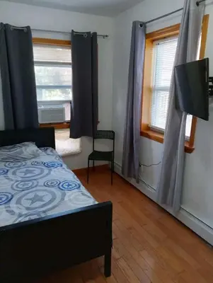 a bedroom with a bed and a window at New York in Woodside