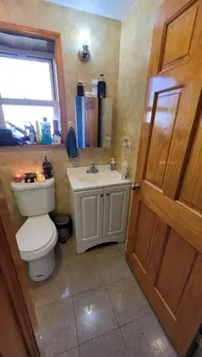 a bathroom with a toilet and a sink at New York in Woodside