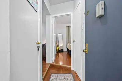 a hallway with a door open to a room at 1BR Apt Walk to Central Park and Columbia University in New York