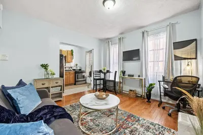 a living room with a couch and a table at 1BR Apt Walk to Central Park and Columbia University in New York