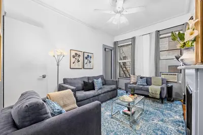 a living room with two couches and a tv at 2BR Apt Walk to Restaurants & Time Square in New York