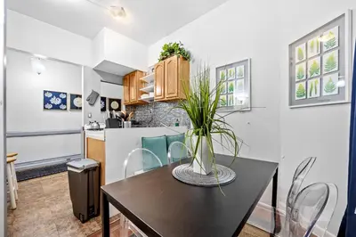 a kitchen with a table with a vase on it at 2BR Apt Walk to Restaurants & Time Square in New York