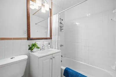a bathroom with a sink and a toilet and a tub at 2BR Apt Walk to Restaurants & Time Square in New York