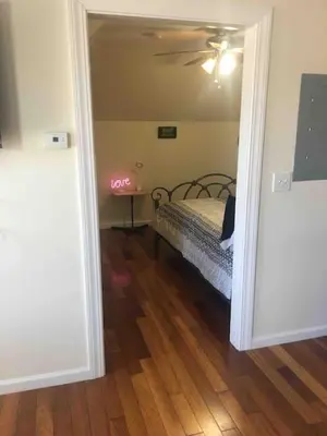 a bedroom with a bed and a table with a ceiling at Lovely one bedroom with free parking in Schenectady