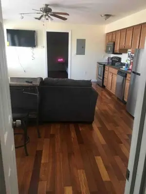 a living room with a couch and a kitchen at Lovely one bedroom with free parking in Schenectady