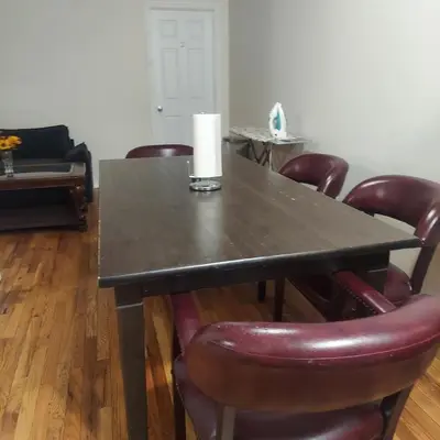 a table with leather chairs and a candle on it at Cosy Bedroom 12mins to Airport Prudential NJIT UMDJ Penn Station in Newark