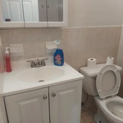 a bathroom with a white sink and a toilet at Cosy Bedroom 12mins to Airport Prudential NJIT UMDJ Penn Station in Newark