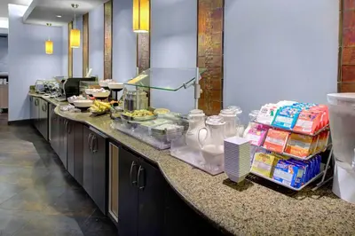a kitchen with a counter with food on it at HYATT House Shelton in Shelton