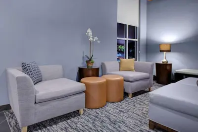 a living room with two chairs and a couch at HYATT House Shelton in Shelton