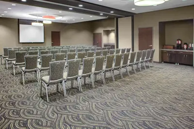 a row of chairs in a room with a podium at HYATT House Shelton in Shelton