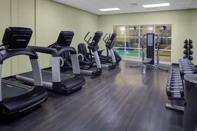 a gym with several treadmills and cardio machines at HYATT House Shelton in Shelton
