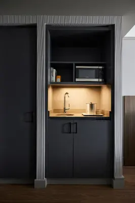 a kitchen with a sink and a microwave at The Melrose Hotel in Bronx