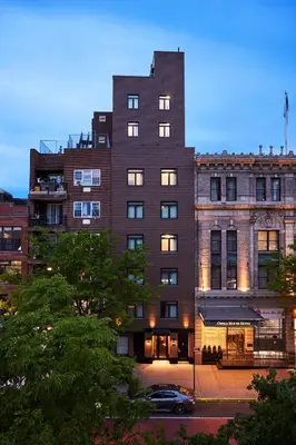 a building with a car parked in front of it at The Melrose Hotel in Bronx