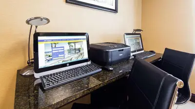 a desk with a laptop computer and a printer at Best Western Springfield West Inn in West Springfield