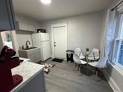 a kitchen with a table and chairs and a white refrigerator at Perfect stay for couples in Springfield